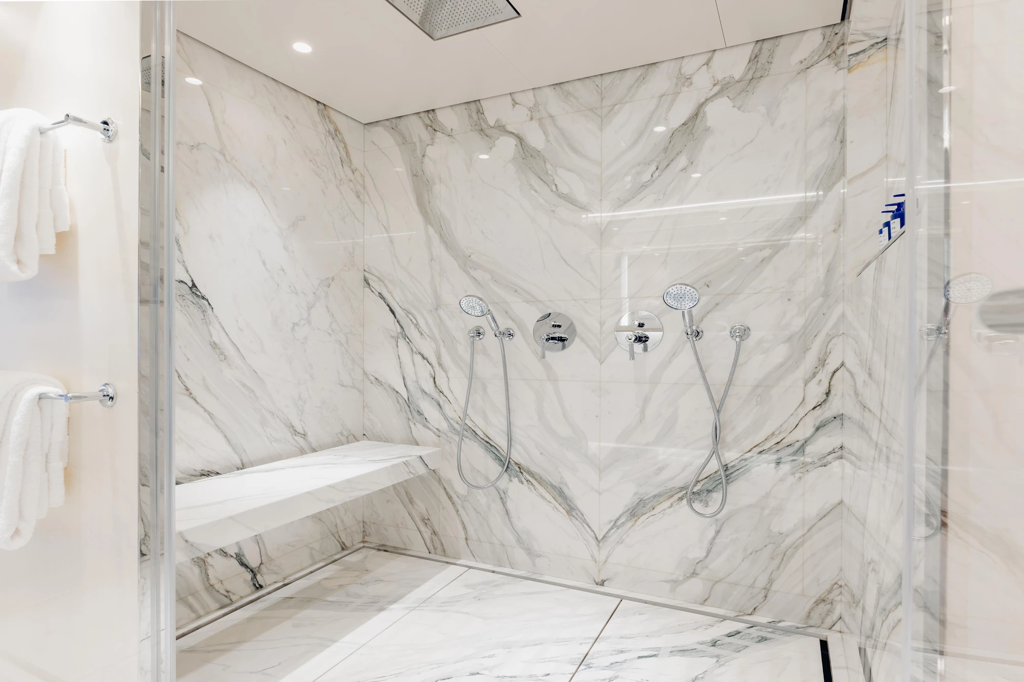 DAYBREAK en-suite master bathroom with marble shower and onyx detailing